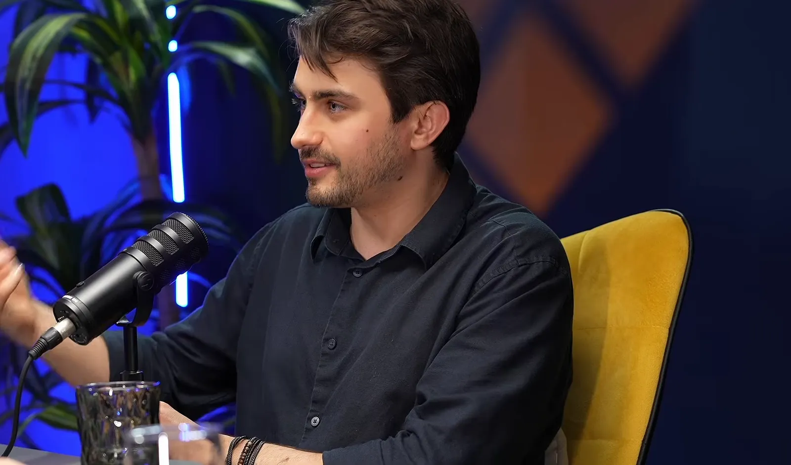 Vlad Tudor mid-conversation in a podcast studio